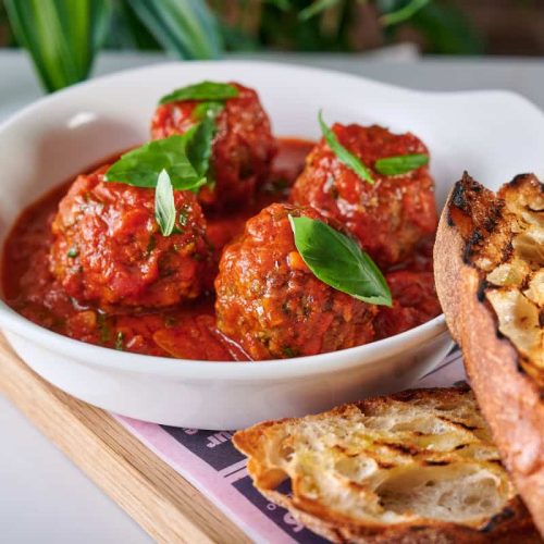 gino-d-acampo-newcastle-pizza-food Meatballs and garlic bread on a serving plate